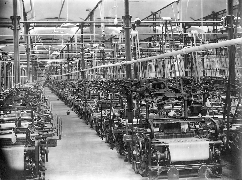 Textile factory worker at modern Japanese machinery 1980s Khatau innovation era