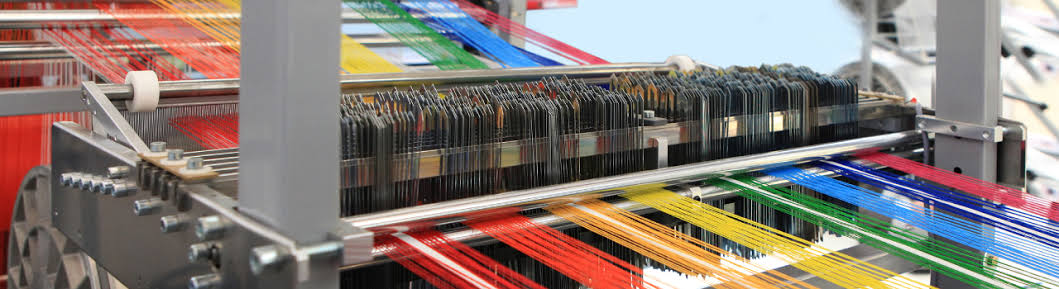 Modern colourful textile loom representing Khatau Fabrics and Shreenath Traders today